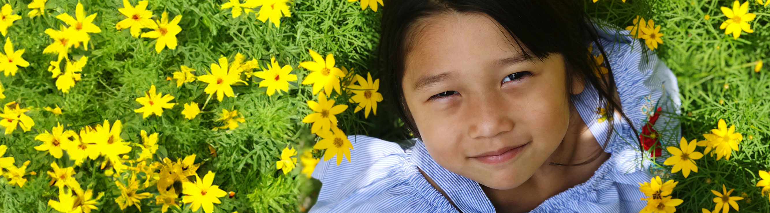 girl smiling with yellow flowers