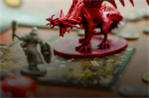 Dragon and charecter game pieces on a board