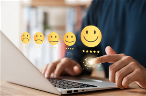 review emoji's options over person sitting in front of laptop
