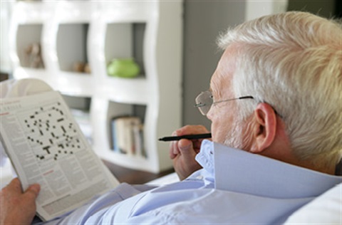 man doing a crossword puzzla