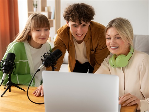 three people looking at a computer