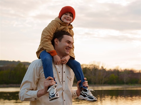 a father with his son on his shoulders