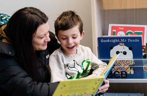 lady reading to a young boy