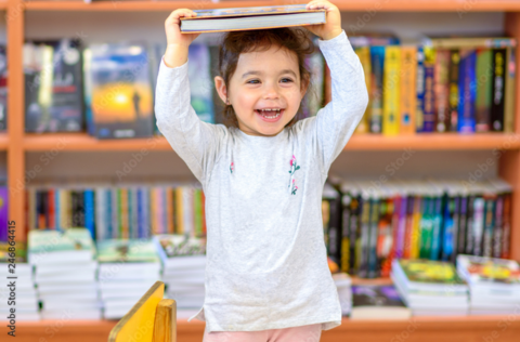 child with book on her head