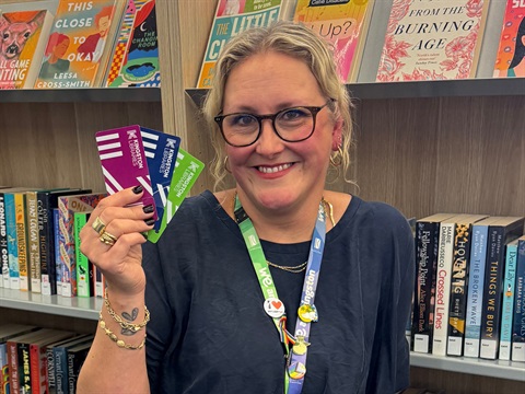 person holding library cards