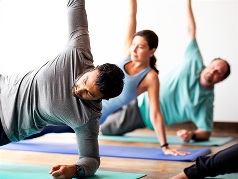 three people doing yoga