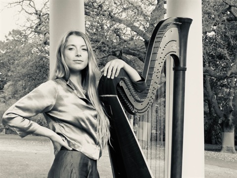 harpist next to her harp