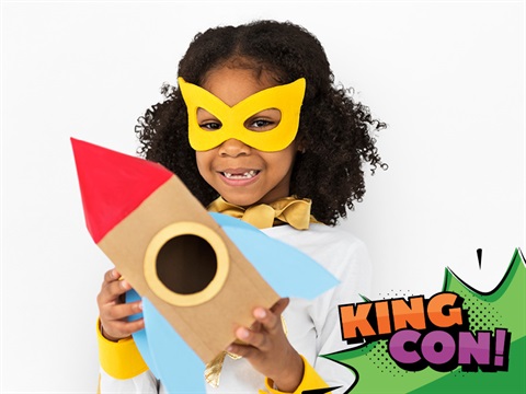 girl holding cardboard rocket