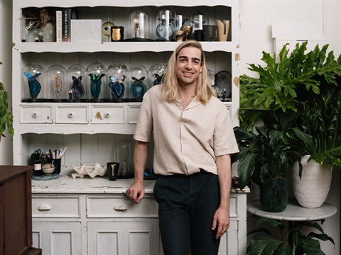 entomologist standing next to a cupboard
