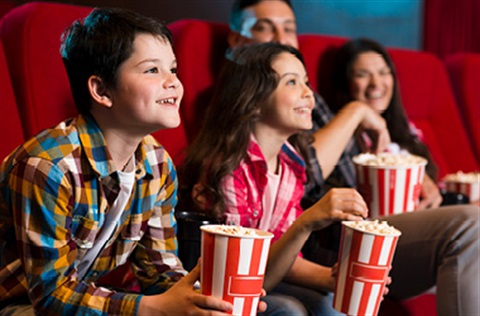 family in cinema with popcorn 