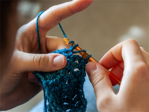 person crocheting