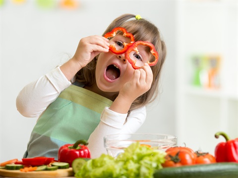 child using capsicum as glasses