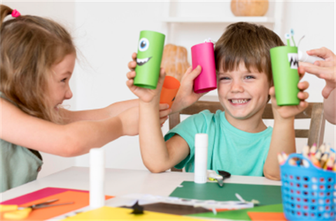 Two children playing with craft materials