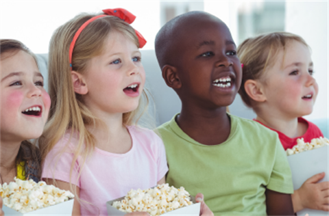 Four children with popcorn