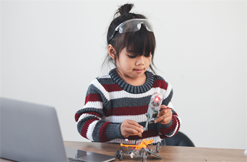 girl playing with electronic toy kit