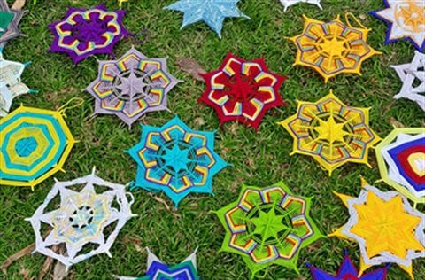 star shapes made from weaving wool lying on grass